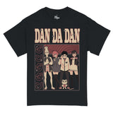 Black T-shirt featuring characters from "Dandadan." The design showcases Seiko, Aira, Okarun, Momo and Turbo Granny. The background features red and black concentric swirls, with vertical Japanese text on the left that translates to "Dandadan." The bold title "DAN DA DAN" is displayed prominently at the top in large beige and red block letters. The overall color scheme uses muted sepia tones with pops of red for a retro, graphic-novel aesthetic.