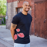Smiling model wearing tee, showcasing wrap-around graphic and fit on a standard male body. 