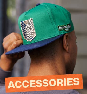 Person wearing green hat with navy bill and Attack on Titan shield embroidered design with banner that reads Accessories