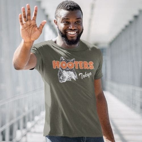 Man wearing black long sleeve shirt featuring a nuclear monster holding Rick and Morty design