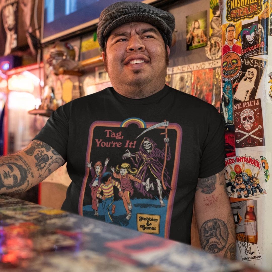 Man wearing heather brown Grateful Dead t-shirt listening to music